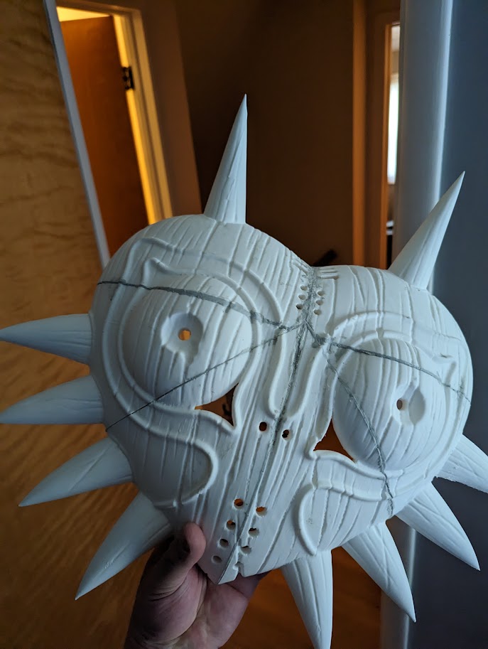 Picture of a 3D printed majoras mask, fused together with polymer clay